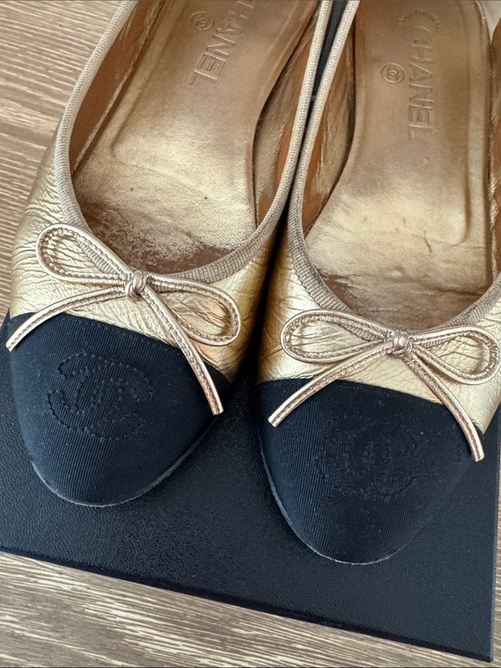 CHANEL Gold Leather Ballet Flats with Black Cap-Toe